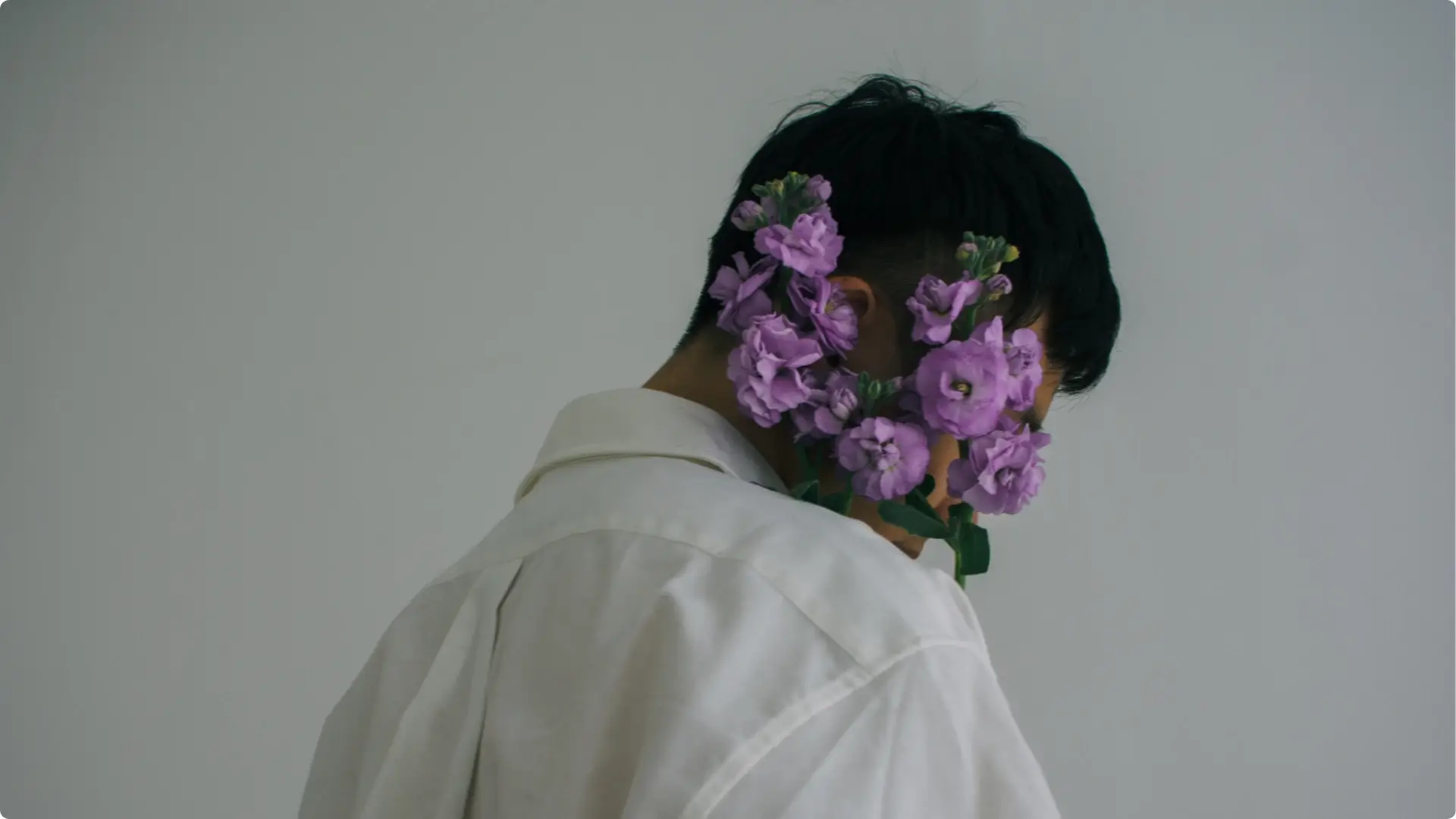 Man with purple flower